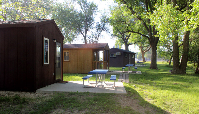 Cabins and picnic tables at Straight Park Campground
