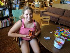 Young woman smiles with project she built