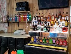 Assortment of alcohol bottles behind bar counter
