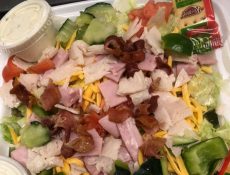 Salad with ham, bacon, cheese, and veggies