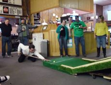 Group of people playing a pool/mini golf game