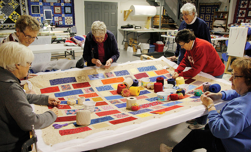 Group of women working on a quilt